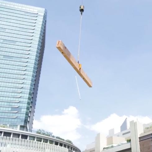 クレーンで木材をつり上げる
